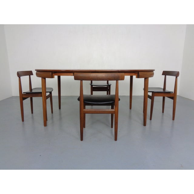 Extendible teak table and four chairs manufactured by Frem Røjle and designed by Hans Olsen. Chairs and table are made...
