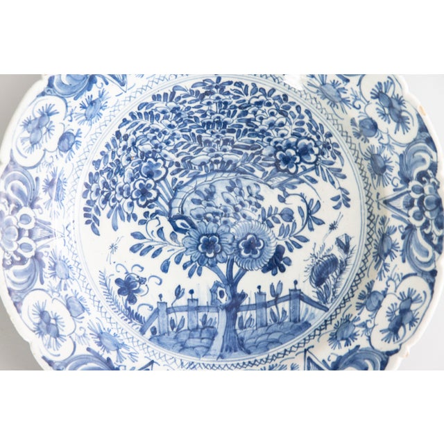 A beautiful large antique 18th Century vibrant blue and white Delft faience 'tea tree' charger plate featuring a scalloped...