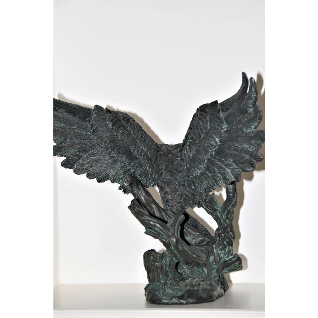 This powerfully detailed heavy sculpture features a fierce mighty bird with wings spread detailing carved feathers....