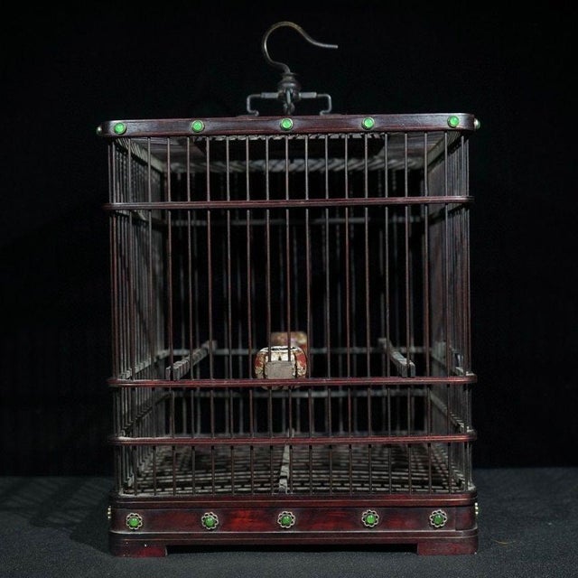 A magnificent vintage Chinese birdcage intricately crafted from dark rosewood (Hong Suanzhi). The cage features fine...