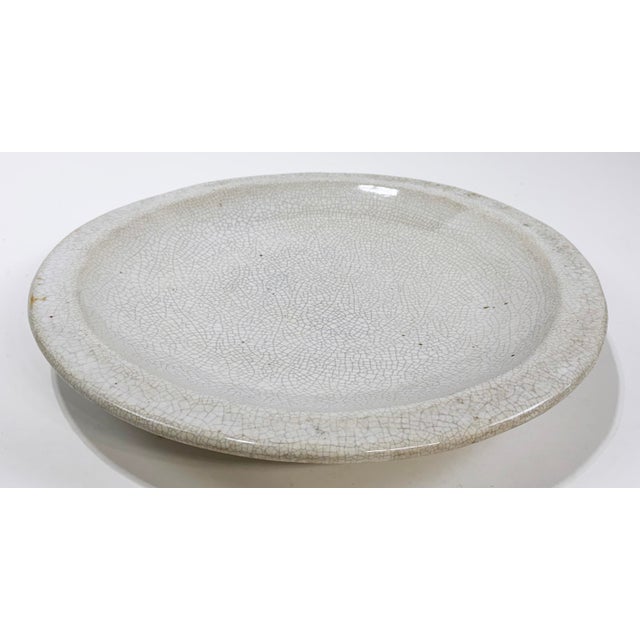 Large round vintage studio pottery platter with thick raised rim and natural speckled clay crackled finish. Great presence...