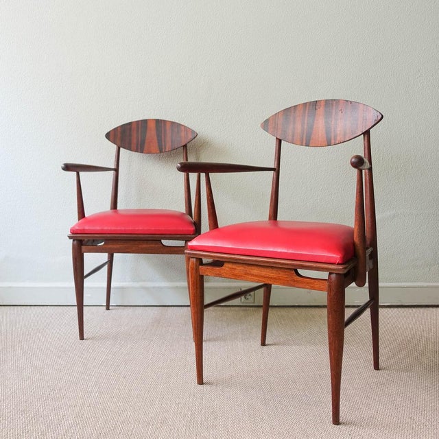 This pair of armchairs was designed and produced in Portugal during the 1950's. They feature a sucupira wood structure,...