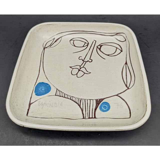 Offered is a vintage Susana Espinosa glazed redware decorative plate with an abstract portrait of a man, signed on the...