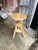 Industrial style light wood adjustable, three-legged stool. Ideal for use as extra seating or as a small table.