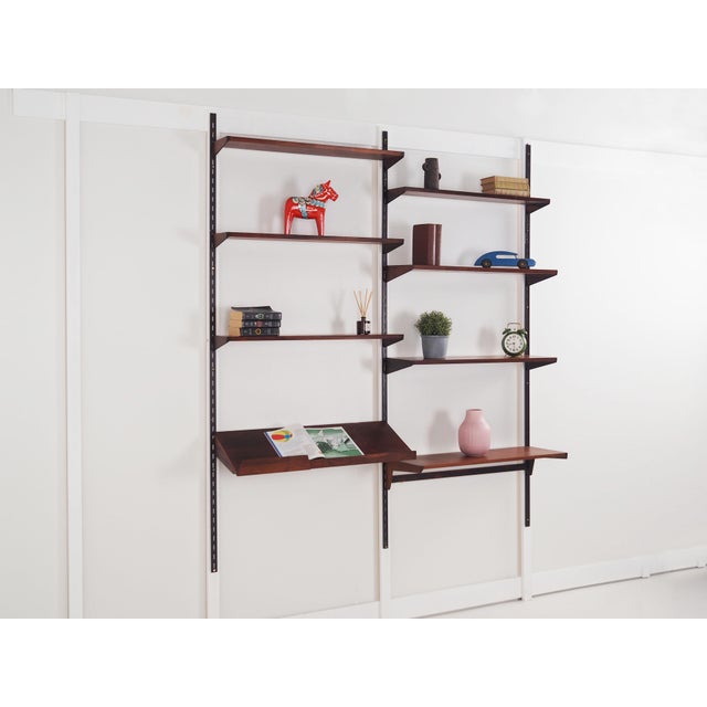 The system bookcase was made in the 1960s, Danish production. The structure is covered with rosewood veneer. The surface...