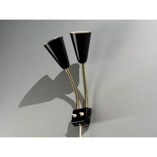 Upsala Armaturfabrik, Swedish Mid-Century Modern, Adjustable Wall Sconce, Black Metal, Brass, Sweden, 1960s A black...