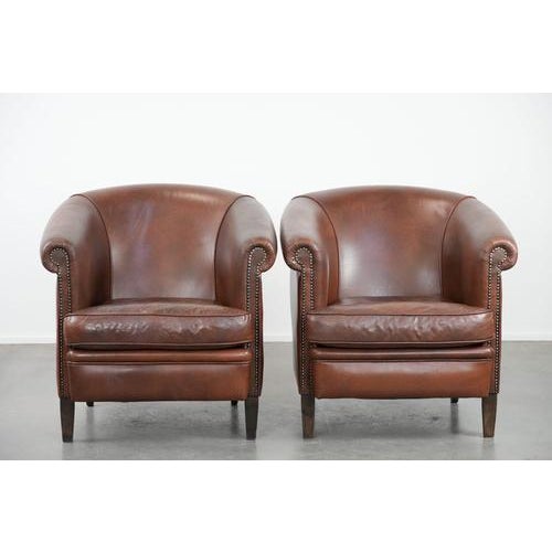 We are offering this unique set of 10 cognac-colored English-style club chairs in cowhide leather with a luxurious look....