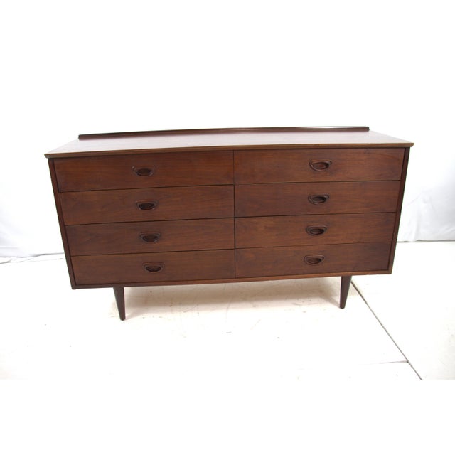 Stunning Danish Dresser in walnut with 8 total drawers for plenty storage. Dresser has a dark walnut stain finished. The...