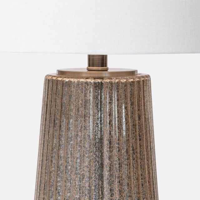 The Danette Table Lamp This lovely mercury glass and crystal table lamp from Made Goods, The Danette, sets a gleam from...