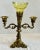 The fine epergne is fitted with a yellowish / green scalloped glass holder and is flanked by a pair of extended arms for...