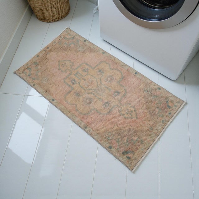 Vintage Turkish Hand-Knotted Small Rug from Oushak, 1970, featuring warm blush-peach tones and authentic village...