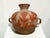 Charming vintage Mexican folk art pottery vase featuring a rounded body, flared neck, and two decorative loop handles....