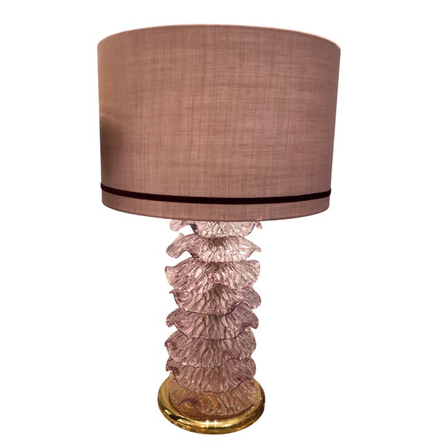 This piece was handcrafted in the Murano region of Italy. A pair of lamps from the 1980s, with a gilded brass frame topped...