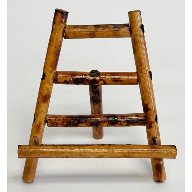 Vintage petite table easel featuring scorched bamboo frame. Art rest measures 3.5"L. Age wear.
