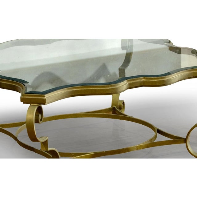 Coffee table. Portuguese, 20th century; metal frame; cut-out glass top. Dimensions: 52 x 121 x 121 cm.