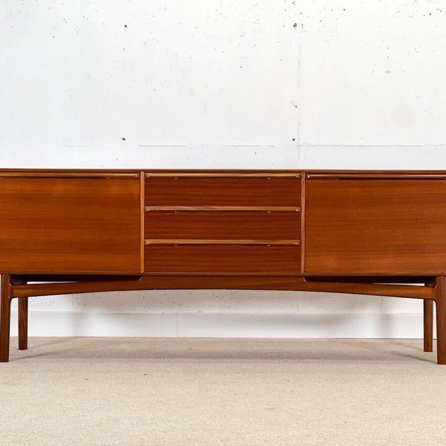Stunning and unusual mid-century sideboard designed by Tom Robertson for cabinetmaker A.H. McIntosh in Scotland for the...