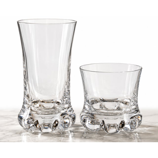 A striking and unusually complete 20-piece collection of vintage Kosta Boda “Buster” glassware, designed by celebrated...