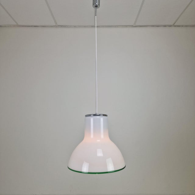 An exceptional and large mid-century modern pendant light, masterfully crafted in italy during the 1970s. this striking...