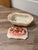 This item is a vintage mid-century ceramic or porcelain lidded trinket box, likely made in Japan, featuring a pink and...