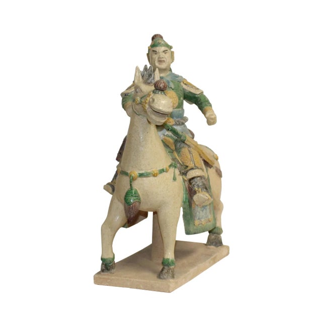 This is a handmade Chinese accent decorative figure of an ancient style warrior on a horse in cream white glaze and color...