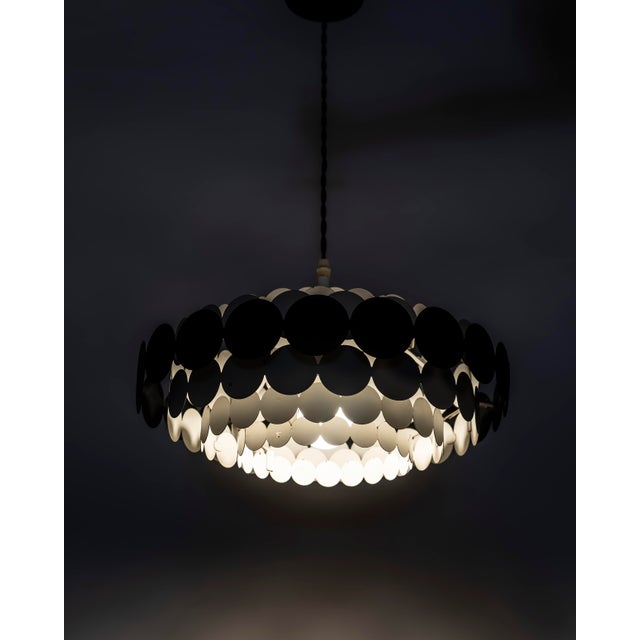 An original pendant lamp produced by Doria Leuchten in Germany during the 1960s, a design that fully reflects the formal...