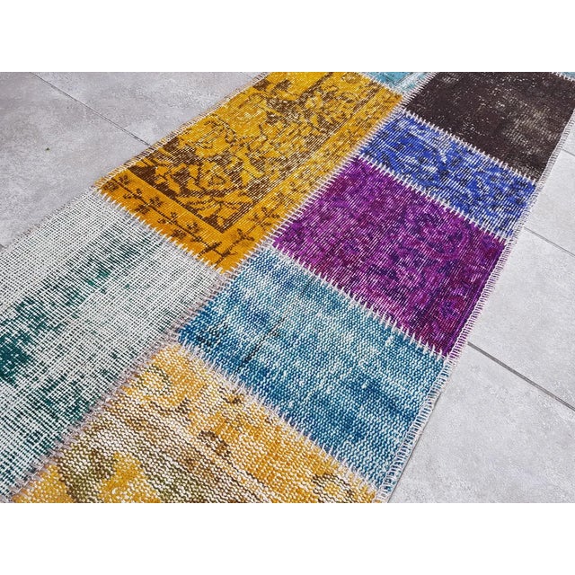 This is a vintage Turkish Oushak rug from the Mid 20th Century. The piece was hand-knotted.