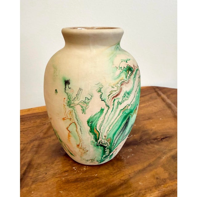 Vintage medium size Nemadji pottery vase. Shades of green with a burnt orange swirl on a cream back ground. Made pre...