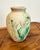 Vintage medium size Nemadji pottery vase. Shades of green with a burnt orange swirl on a cream back ground. Made pre...