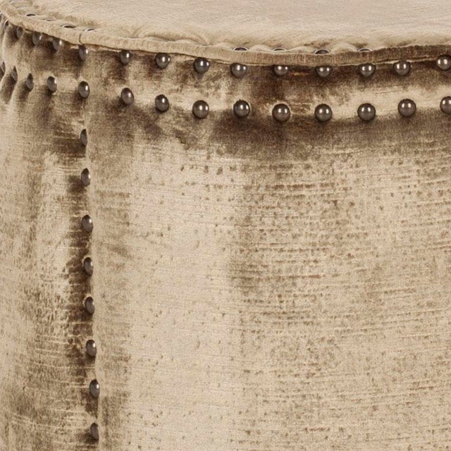 The rustic-chic ottoman complements contemporary and transitional interiors with it's tall drum shape, oversized brass...