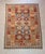 vintage Afghan Maimana kilim rug featuring bold tribal geometric patterns and a warm, earthy color palette. Handwoven with...