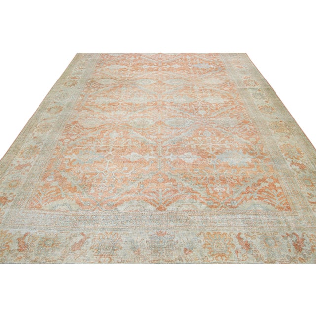 Beautiful antique Persian Sultanabad hand-knotted wool rug with an orange field. This piece has a light blue designed...