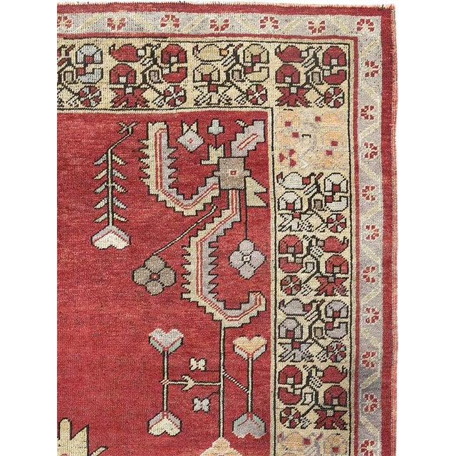 This mid-20th-century Turkish Anatolian wide gallery runner presents a bold, symmetrical composition across a rich brick-...