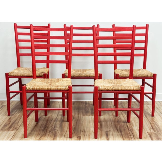 Set of five (5) vintage ladderback chairs with vibrant red painted frames and woven rush seats. Modern meets traditional...