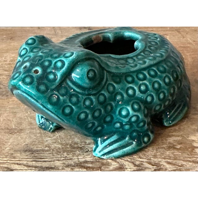 Bring a touch of whimsy and vibrant color to your home or garden room with this delightful vintage ceramic frog planter....