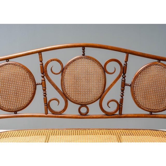 Austria, ca. 1890. A charming Art Nouveau settee or bench by Fischel. Features classic bentwood construction with a high...