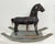 This antique rocking horse is a truly unique decorative item. The charming horse features a deeply weathered black finish...