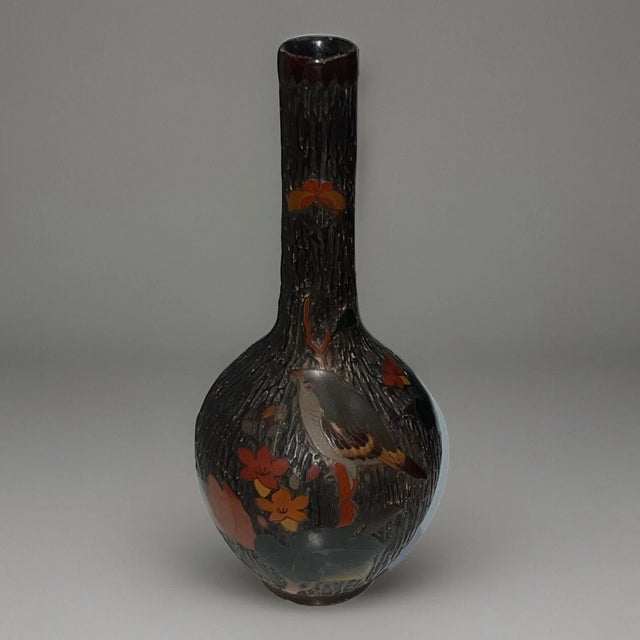 A 19th century Japanese cloisonné vase of tall bottle form, the earthenware body covered in finely crackled glaze and...