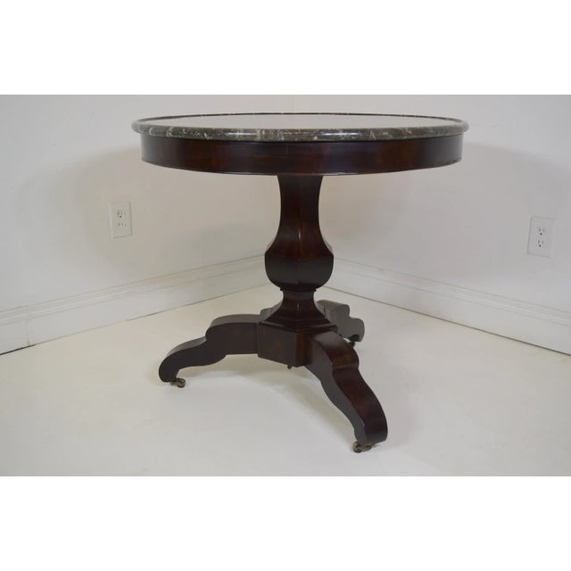Beautiful French Mahogany Gueridon with the original marble. Marble is black & white with a raised rounded lip. Circa...