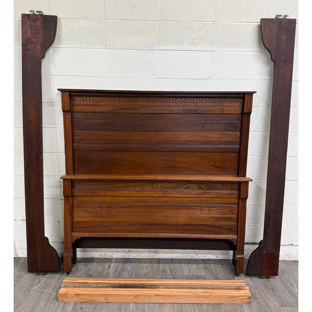 This is a beautiful antique Victorian Eastlake walnut full-size bed dating to the late 19th century, circa 1880–1895....