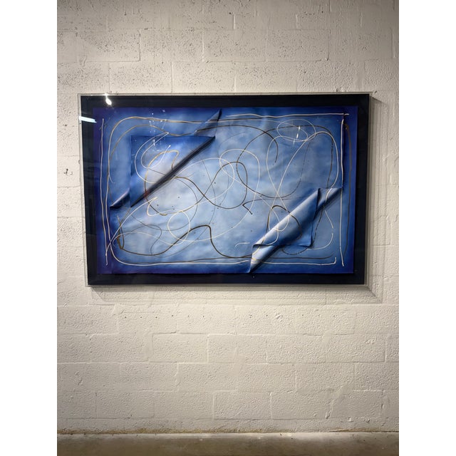 Abstract modern art on paper encased in a plexiglass frame. Sign by unknown artist.