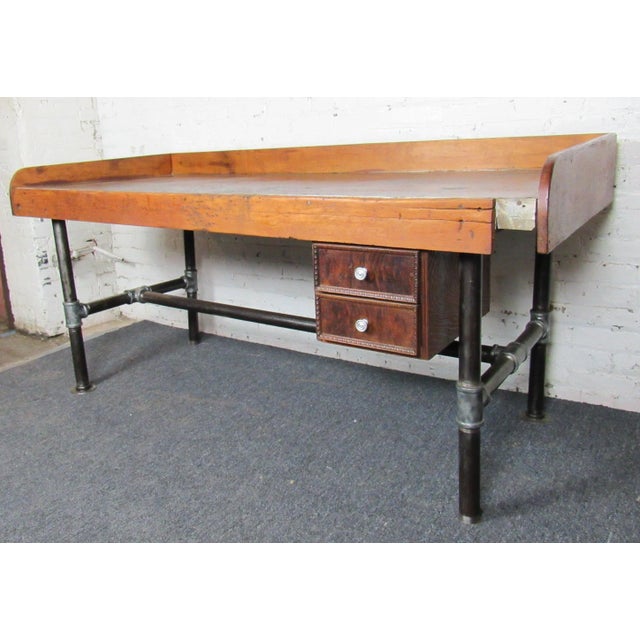 This large and sturdy work table is full of weathered charm and Mid-Century details. Raised edges keep items from falling...