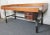 This large and sturdy work table is full of weathered charm and Mid-Century details. Raised edges keep items from falling...