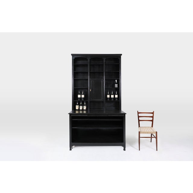 An impressive high French Pharmacy Cabinet in oak. This cabinet was crafted in France around 1910. Elegantly refinished...