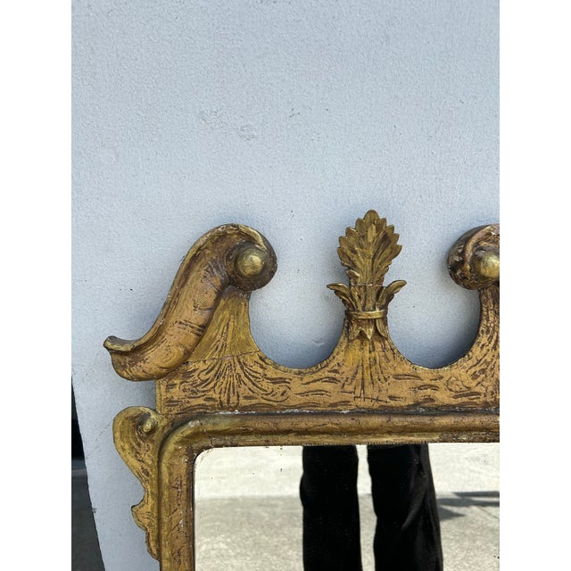Impressive 18th Century English wall mirror, handcrafted, in hardwood with a broken pediment top and floral carvings...