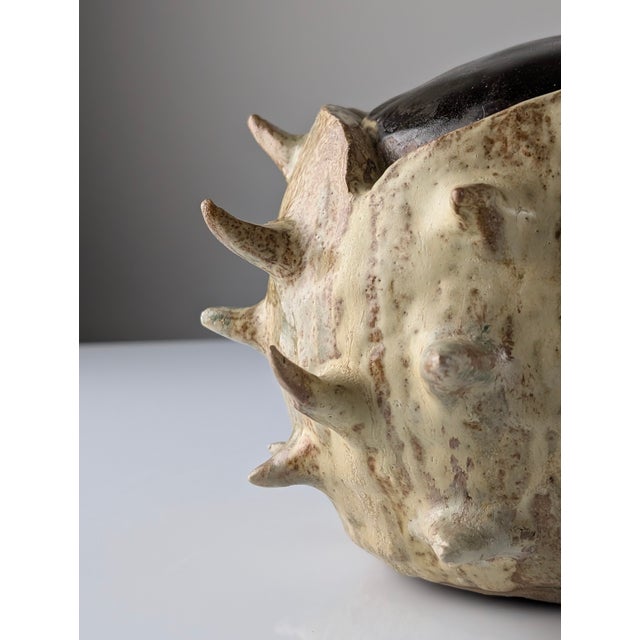 This 20th-century sculptural stoneware piece is a prime example of stoneware craftsmanship, directly inspired by the...