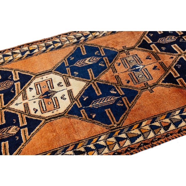 Elevate your space with this striking mid-20th century vintage Turkish runner rug, blending rustic warmth with...