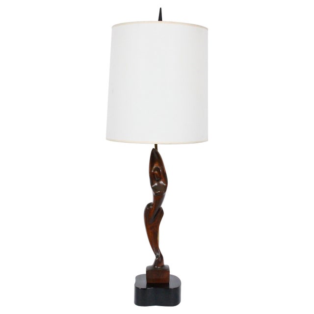 Yasha Heifetz hand-carved mahogany female form table lamp. Handcrafted slim, smooth mahogany figure mounted on free-form...