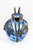 Free-blown marbled glass, colored by surface vitrification: the cobalt blue diffuses in irregular patches on a milky white...