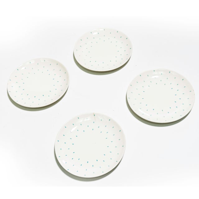 A charming set of four vintage Homer Laughlin plates featuring the classic Dura-Print blue diamond pattern, produced...