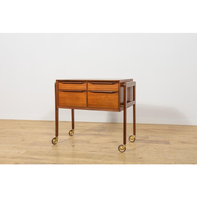 This teak consol was manufactured in Denmark during the 1960s. The piece represents the characteristic qualities of...